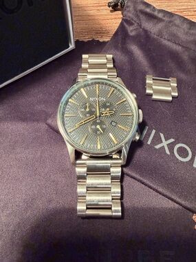 Nixon Silver Stainless Steel Chronograph Watch with Gold Accents